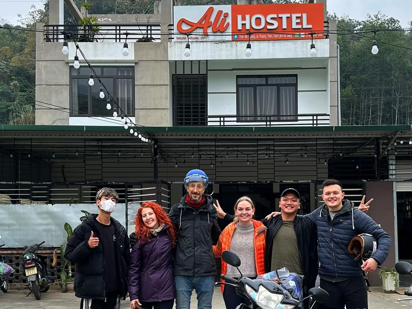 A group of guests with their Ali rider in front of Ali Hostel before the tour