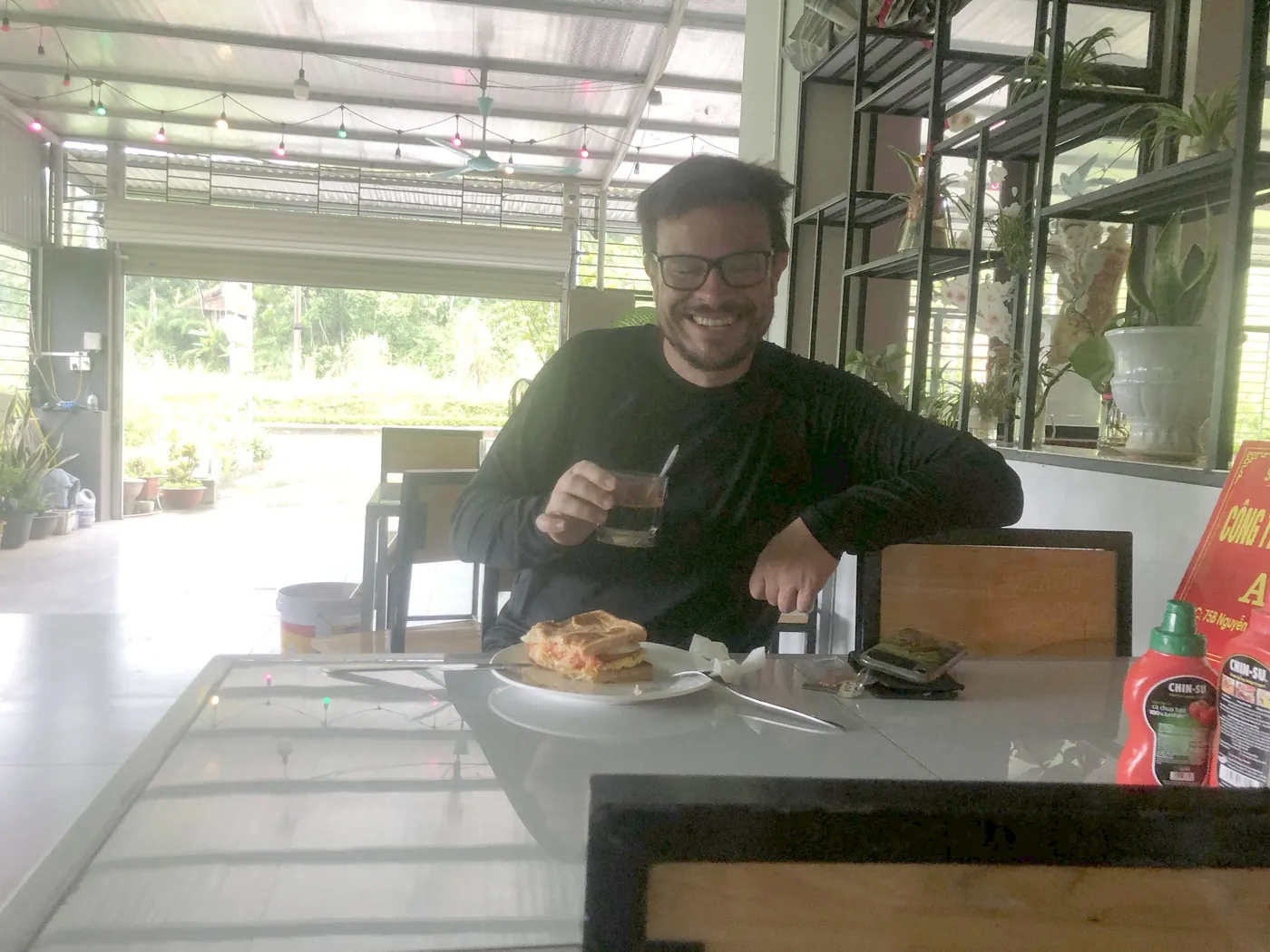 A guest having breakfast at Ali Hostel before riding the Ha Giang Loop