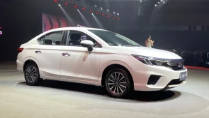 White Honda City sedan shown in side view on a display stage