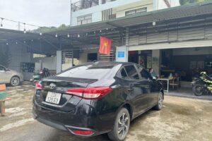 Toyota Vios 2025 rental car in the Ali Hostel courtyard, Ha Giang