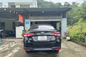 Toyota Vios 2025 rental car rear three-quarter view, Ha Giang