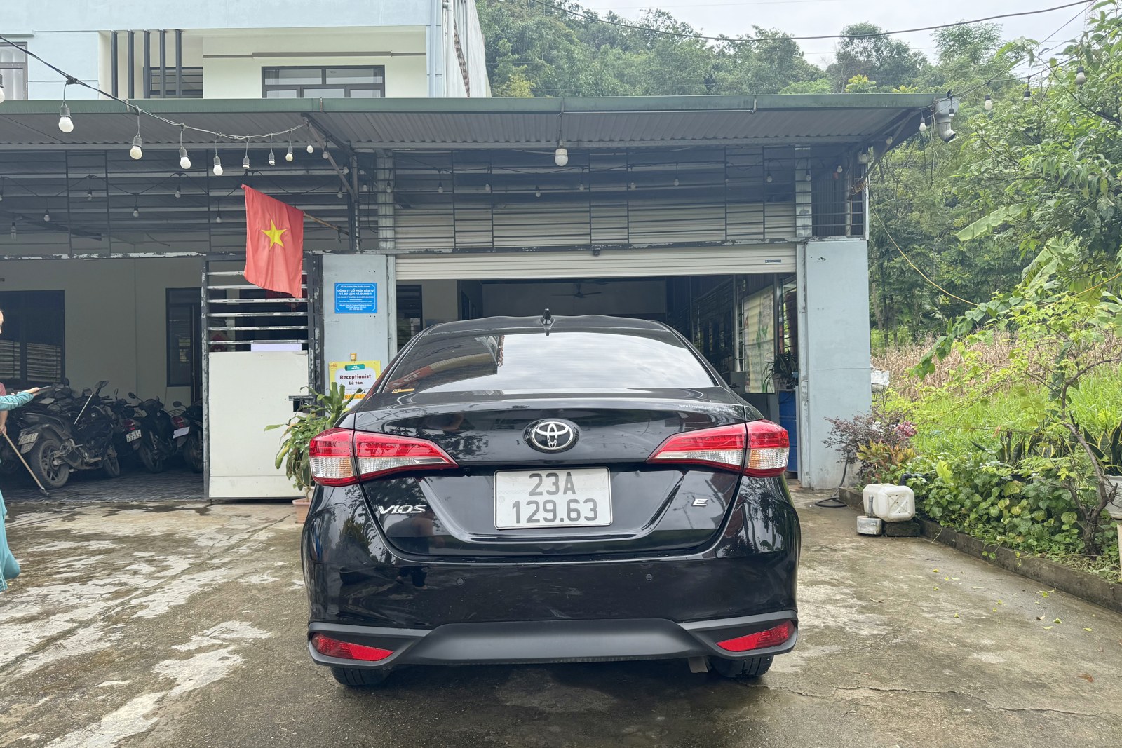 Toyota Vios 2025 rental car rear three-quarter view, Ha Giang