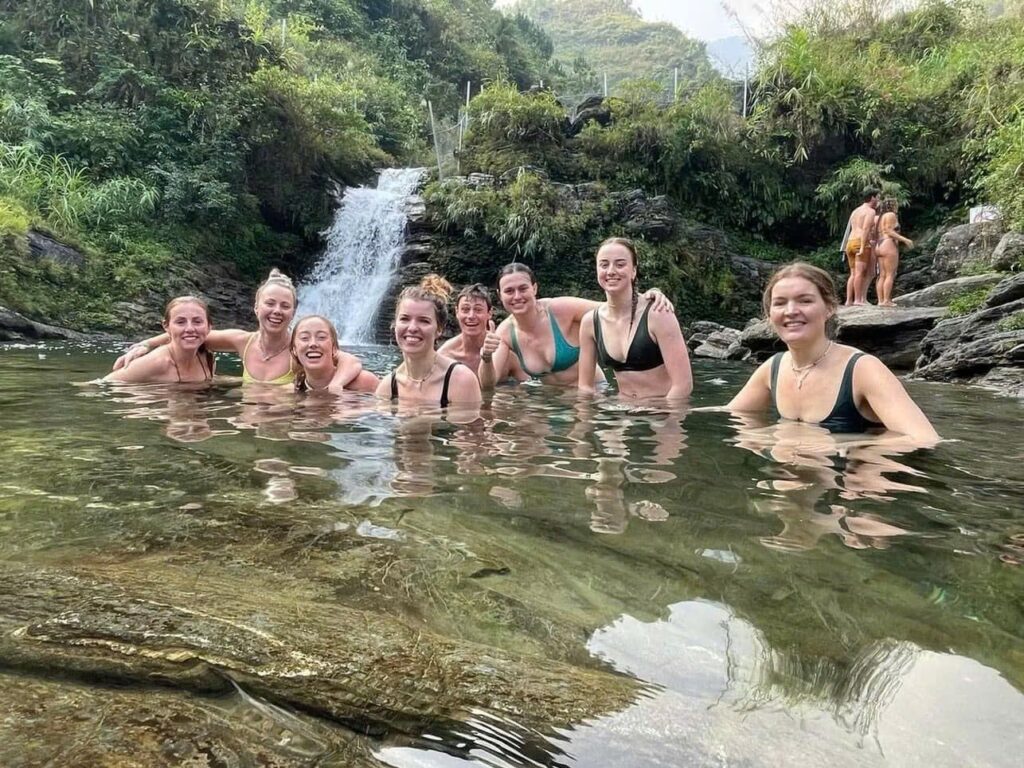 Du Gia Waterfall: A Complete Guide to Ha Giang's Best Swimming Spot 1 Travellers swimming in the natural pool at Du Gia Waterfall, Ha Giang