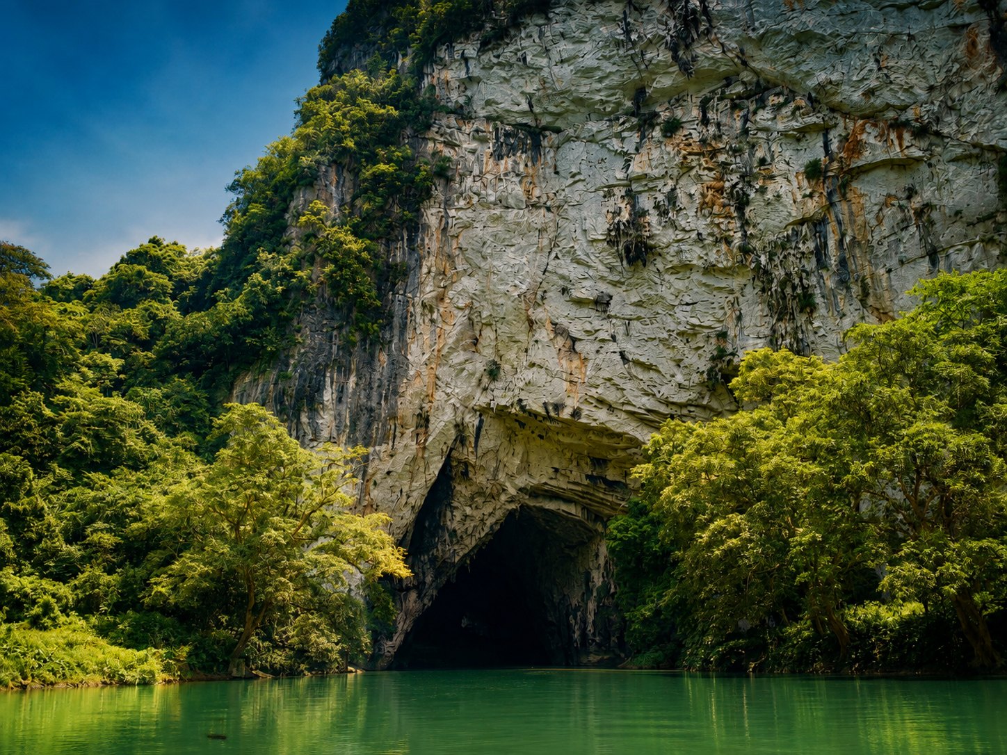 Puong Cave mouth where the Nang River cuts through a limestone mountain near Ba Be Lake
