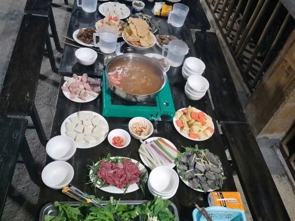 Long hotpot dinner table on the balcony of a Hmong homestay in Dong Van