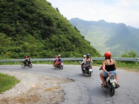 Riders on Ma Pi Leng Pass the morning after a homestay night, riding with a clear head