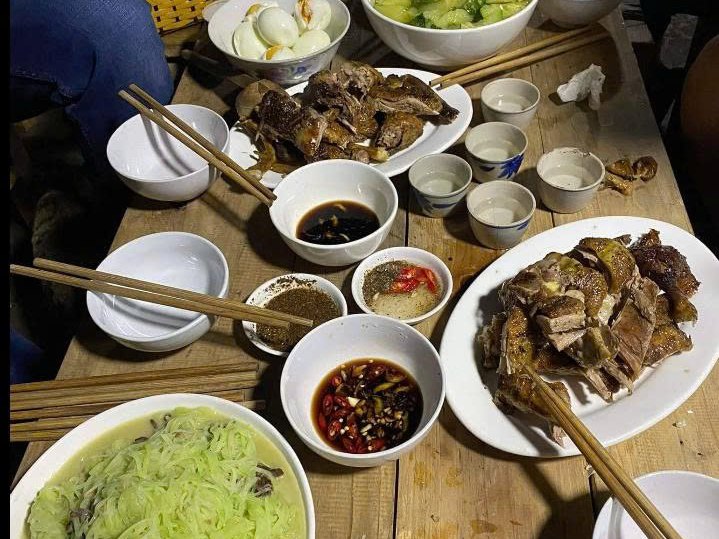 Evening table with small shot cups at a Hmong homestay in Sa Phin