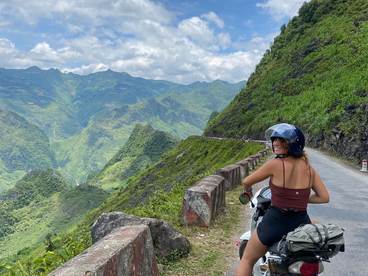A rider stops on Ma Pi Leng Pass, the motorbike alternative to the Ha Giang Loop by car