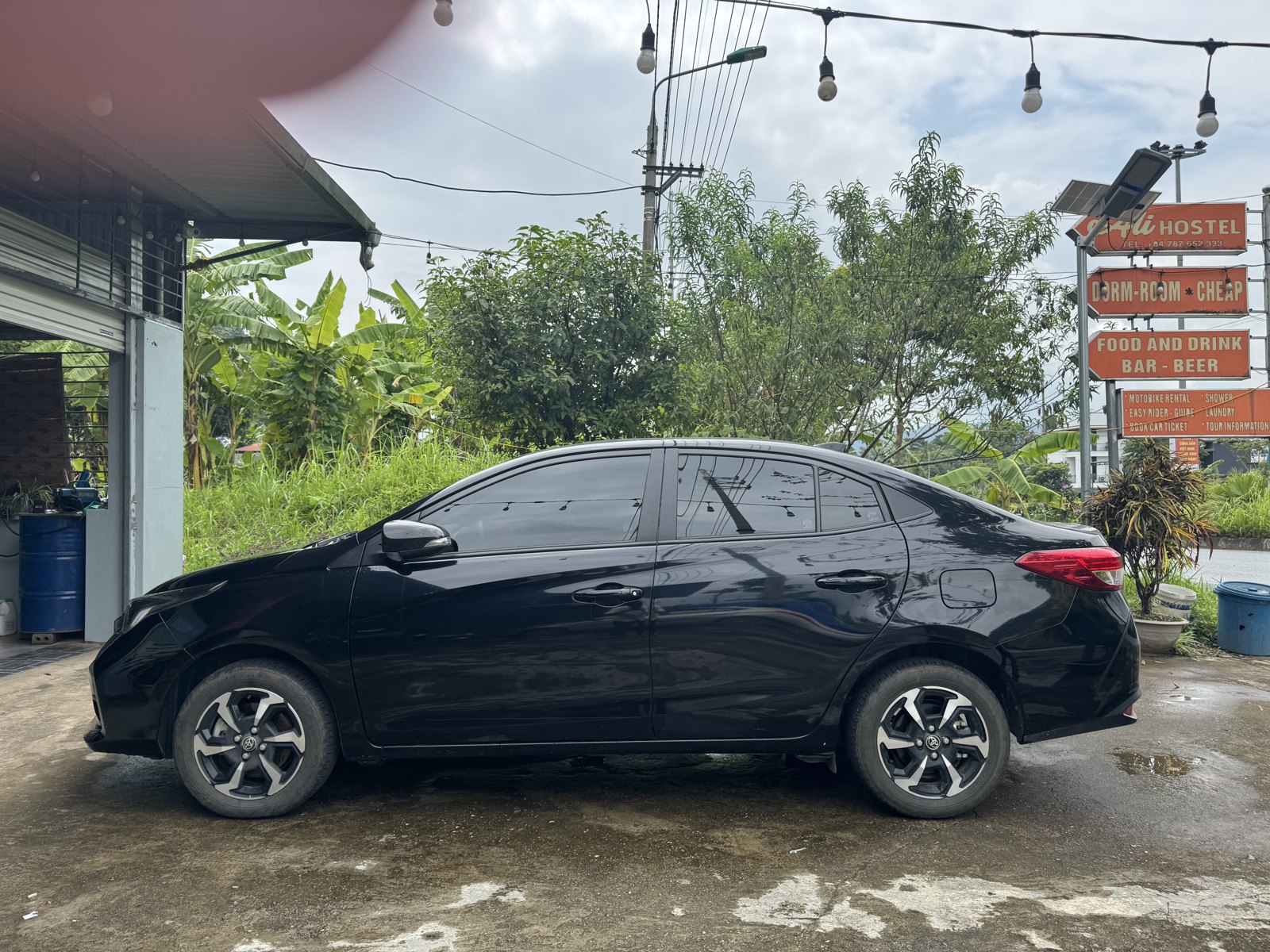 Ali Travel's Toyota Vios parked at Ali Hostel, ready for a Ha Giang Loop by car tour