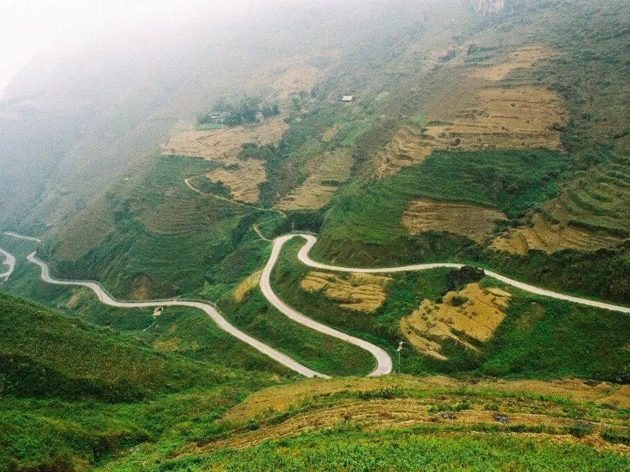 Ma Pi Leng Pass winding road in morning mist, Ha Giang Loop