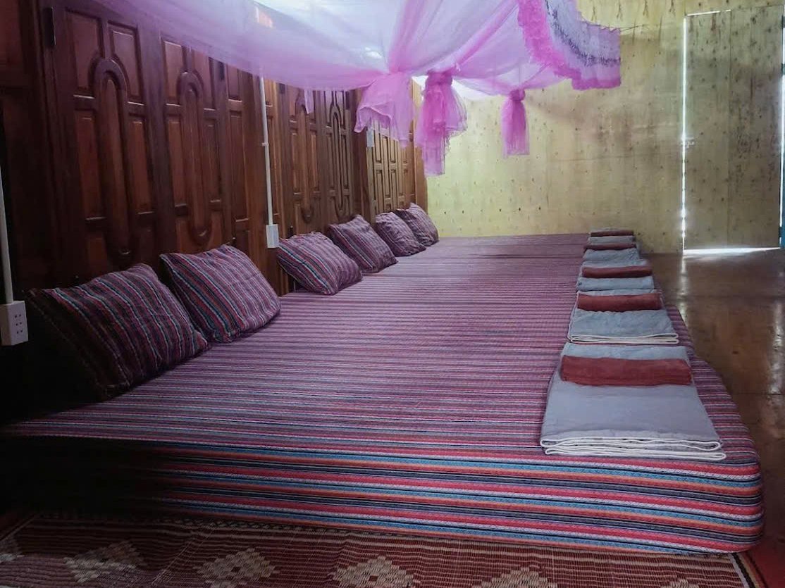 Shared dorm with brocade mattresses at a Ha Giang Loop homestay in Du Gia