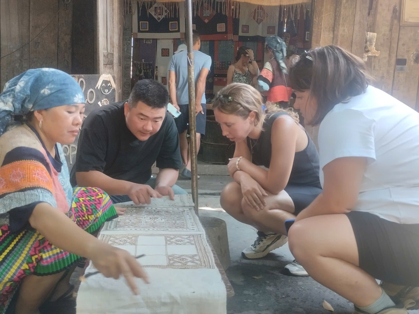 Ali guests learning a traditional Hmong craft from their homestay host on the Ha Giang Loop in August