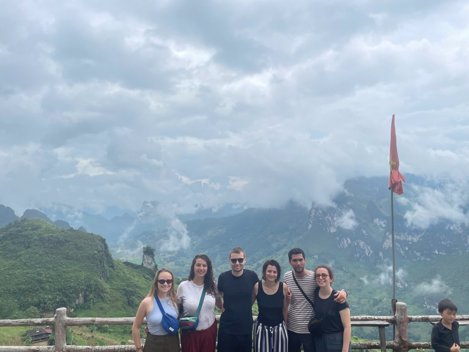 Ali guests at a viewpoint on the Ha Giang Loop in August with summer cloud rolling over green karst peaks