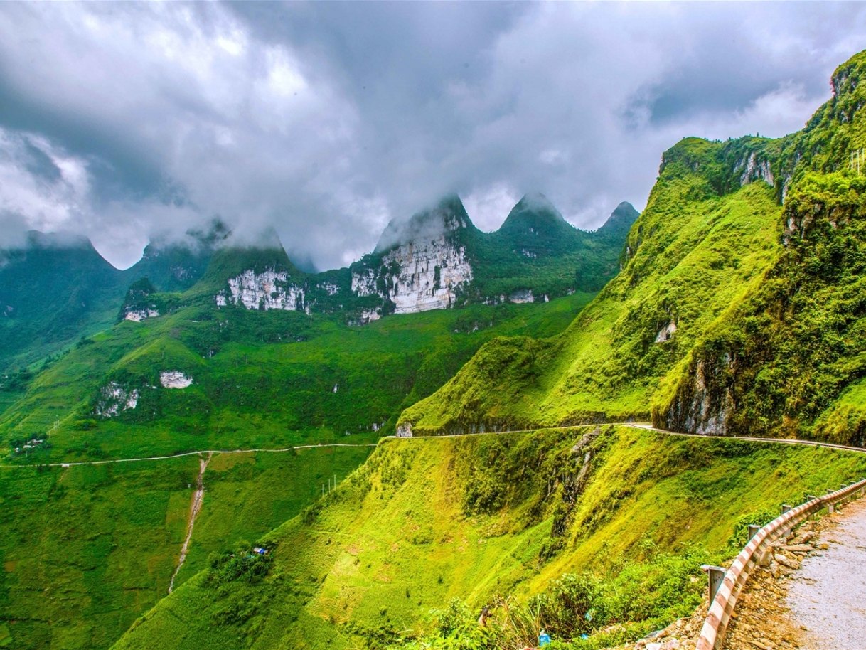 Ha Giang Loop in July: Should You Ride the Wettest Month? (2026 Guide) 3 Storm cloud building over the green Ma Pi Leng road on a summer afternoon in Ha Giang