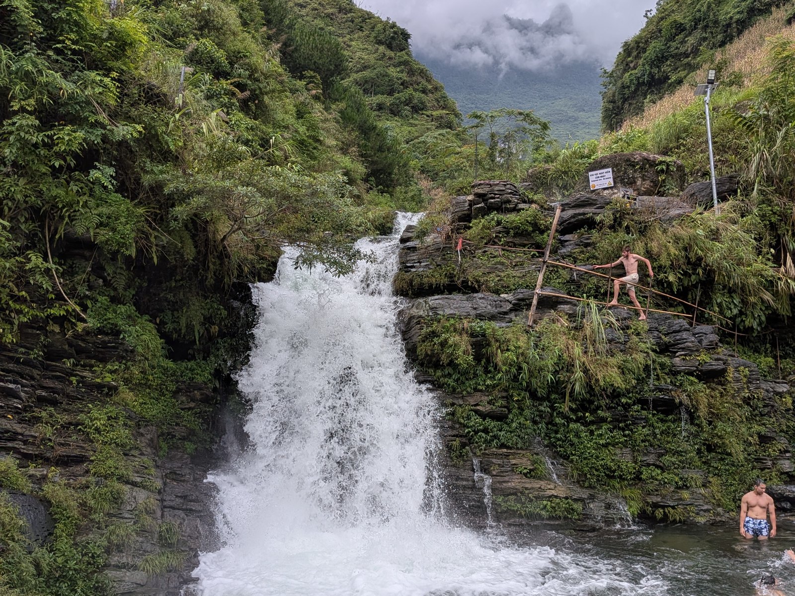 Ha Giang Loop in July: Should You Ride the Wettest Month? (2026 Guide) 7 Guests swimming below Du Gia Waterfall at full summer flow, 2 July 2026, Ha Giang