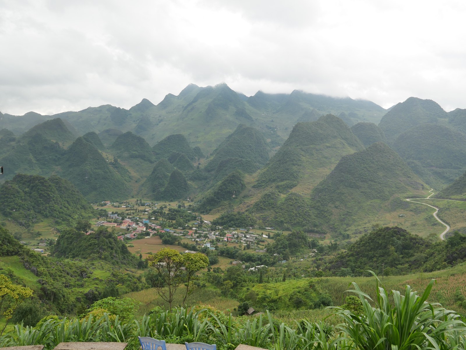 Ha Giang Loop in July: Should You Ride the Wettest Month? (2026 Guide) 2 Ha Giang Loop in July: a karst valley on the Dong Van plateau under heavy summer cloud, photographed by Ali guests on 2 July 2026
