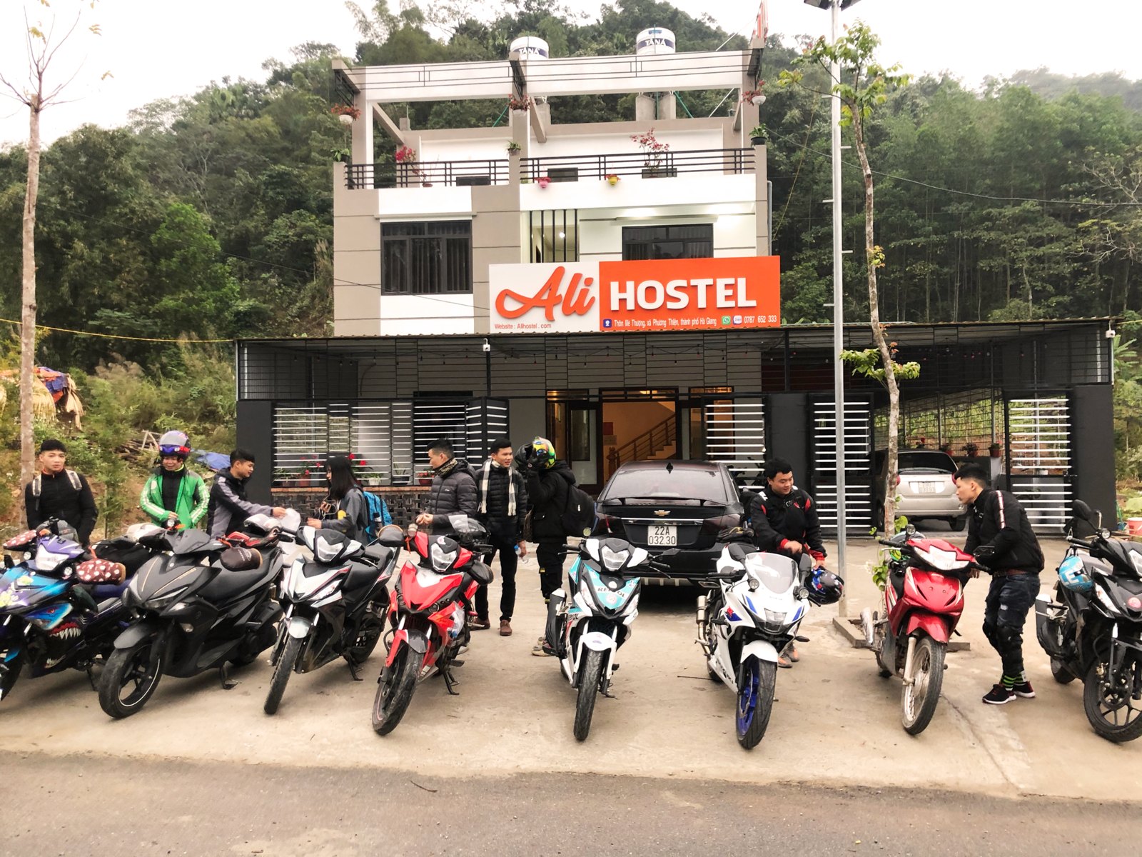 Ha Giang Loop Luggage: Where to Leave Your Big Bag and What to Carry (2026) 4 Motorbikes lined up outside Ali Hostel before a Ha Giang Loop departure