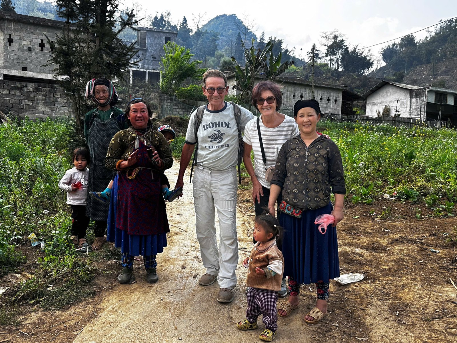 Ali guests with H'Mong villagers and children in a village on the Loop