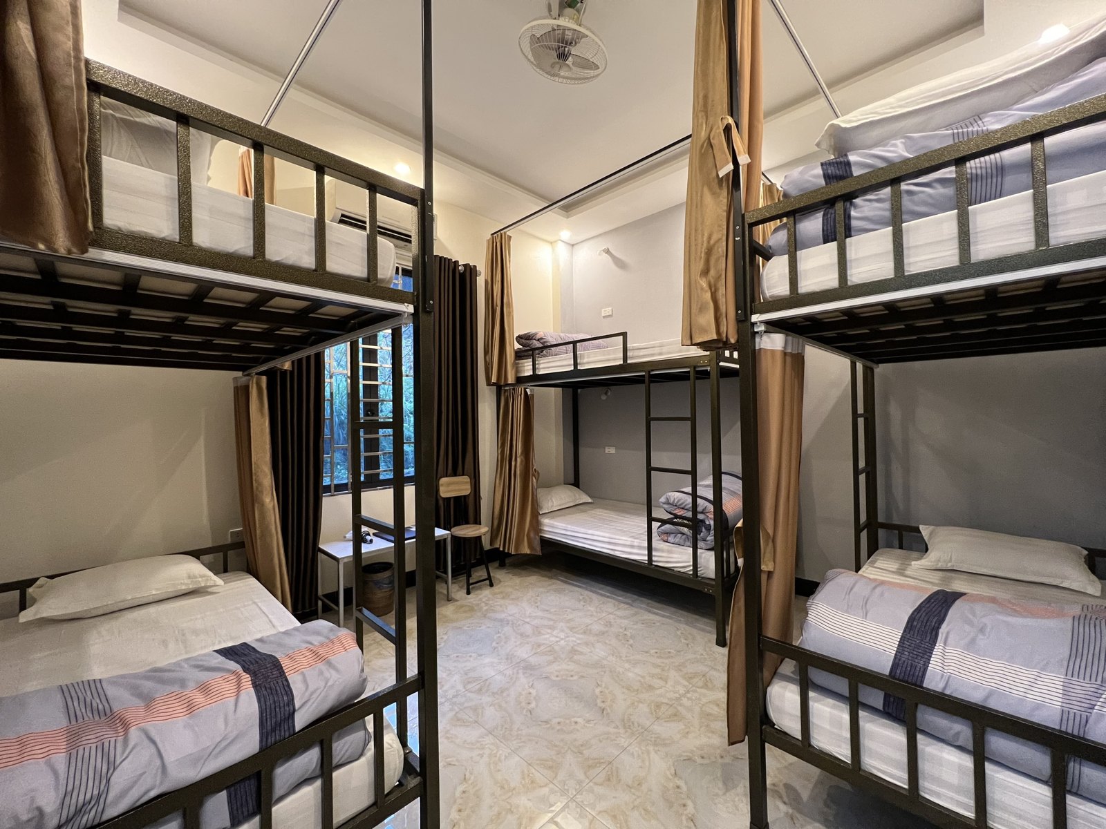Female-only dorm with bunk beds and curtains at Ali Hostel in Ha Giang