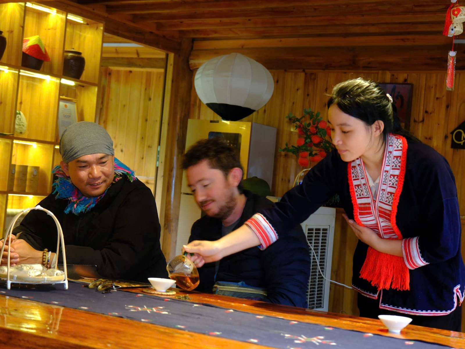 Travellers on the Ha Giang Loop solo trip sharing evening tea with local hosts