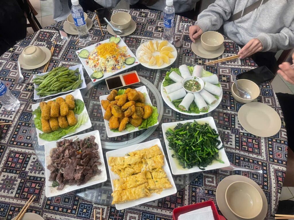 Ha Giang Loop vegetarian: a shared-tray lunch with tofu, greens and spring rolls
