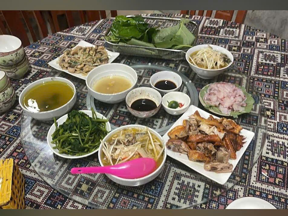 Shared lunch tray with greens, bean sprouts and soup on the Ha Giang Loop