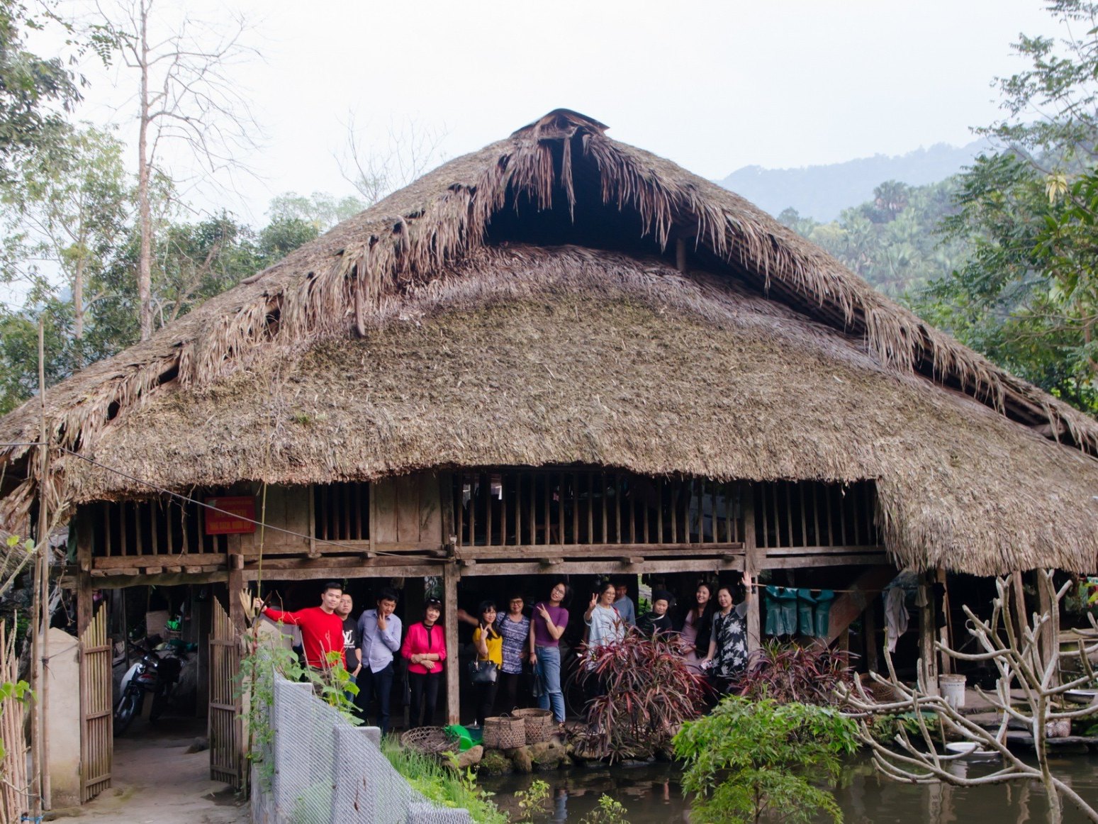 Palm-thatched Tay stilt house in Ha Thanh village, first stop of the trek