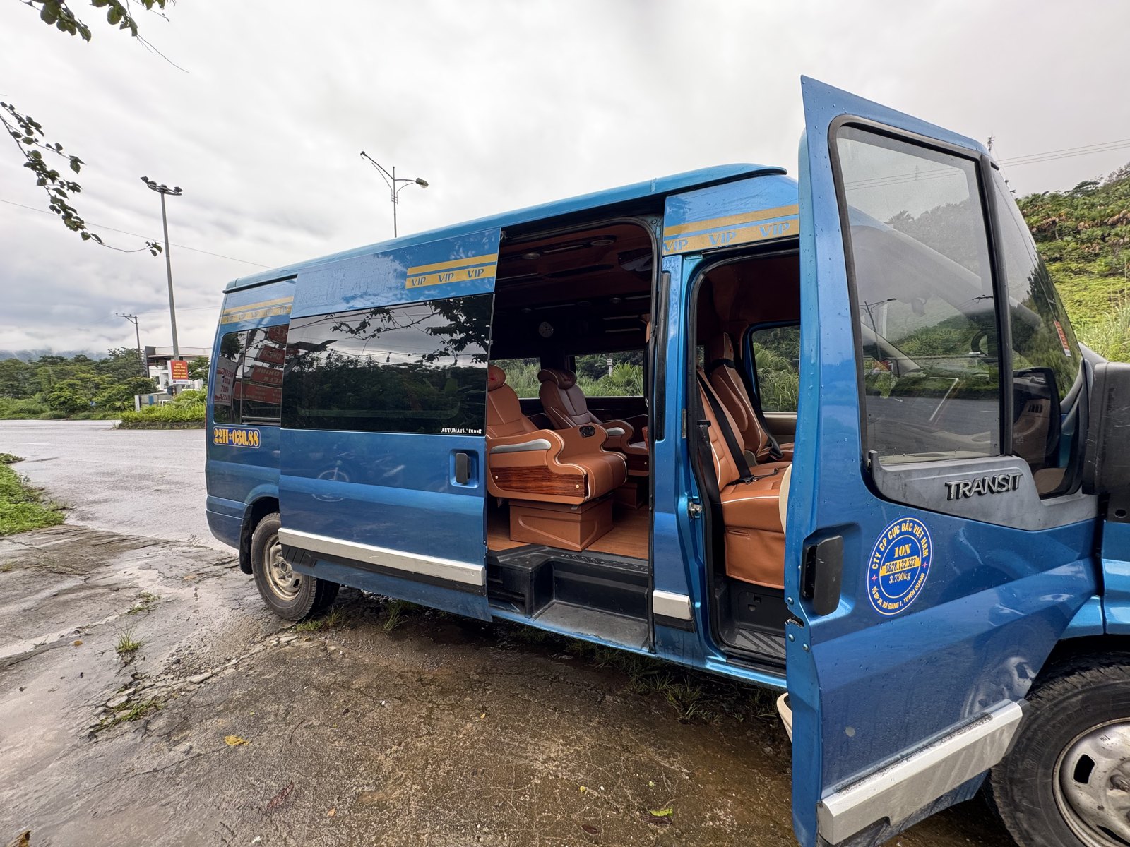 Limousine van on the Hanoi to Ha Giang bus route with its door open, showing leather seats