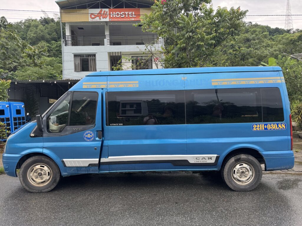 Hanoi to Ha Giang bus: a 16-seat limousine van outside Ali Hostel in Ha Giang city